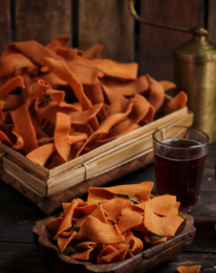 Delicious homemade Indian ribbon pakoda served with tea in a rustic setting.